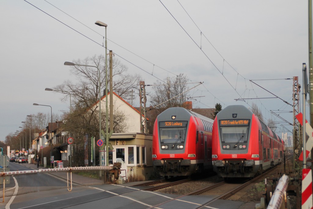 Begegnung zweier Doppelstockzüge am Bahnübergang in Frankfurt-Nies, aufgenommen am 26.02.2016.