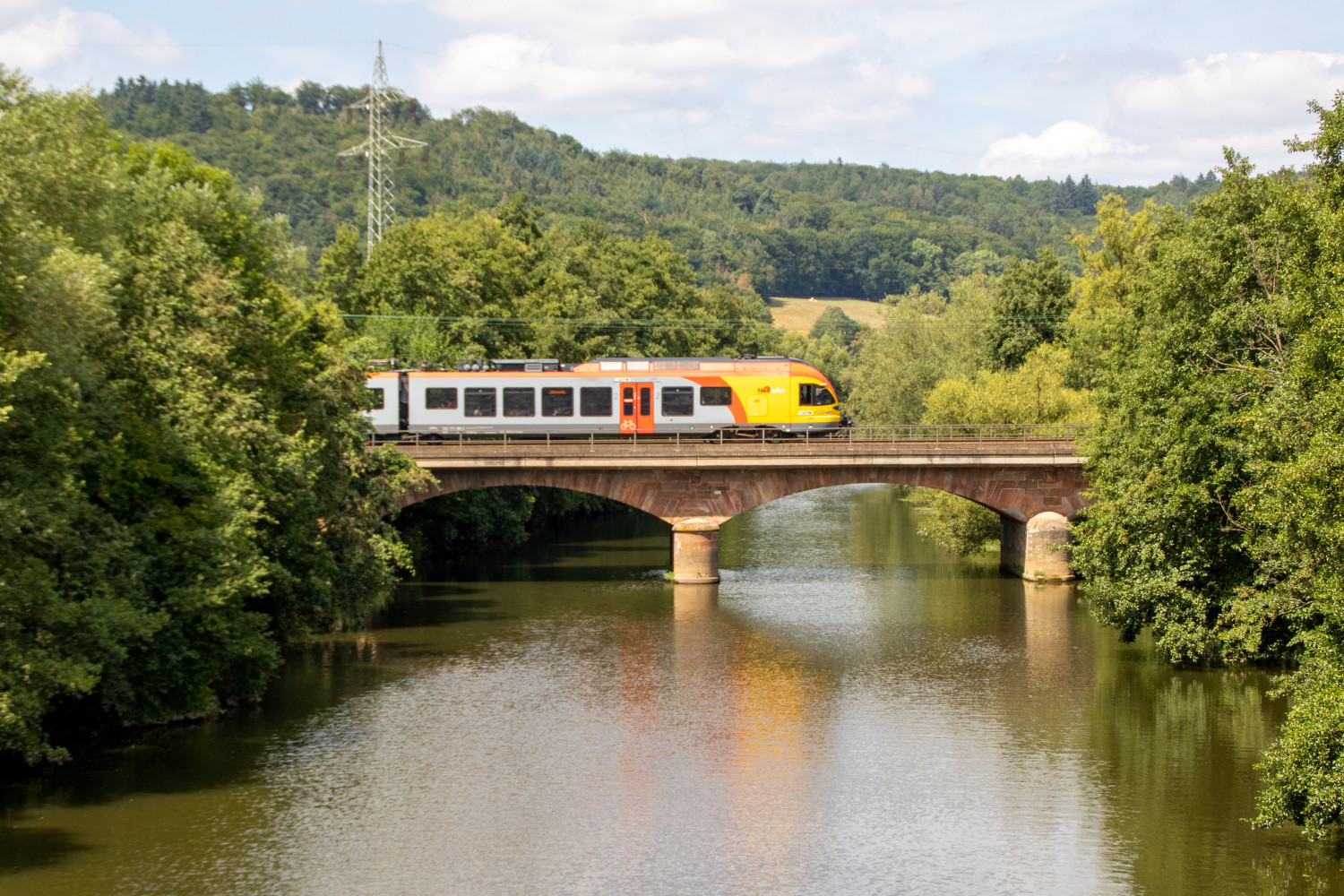 Ein FLIRT der HLB überquert die Lahnbrücke bei Marburg-Gisselberg, aufgenommen am 04.08.2019.